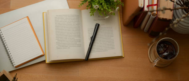istock Study table with books, stationery, mock up notebook, coffee cup and decorations on wooden table 1257321590