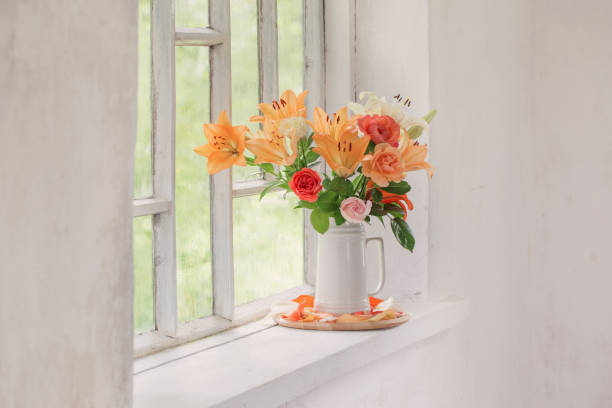 istock summer flowers in vase on background window with drops water 1257324917