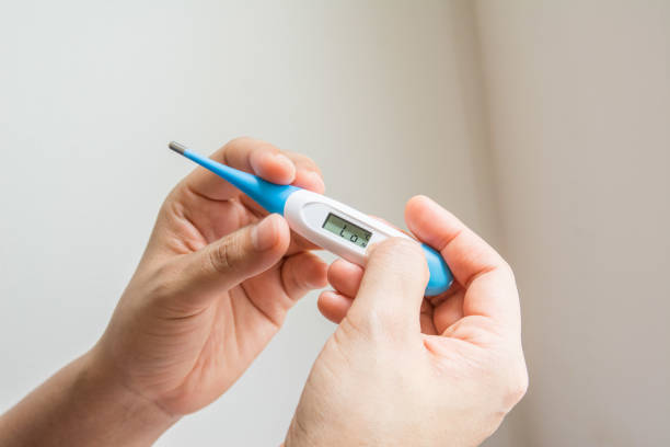 istock Women hands holding a digital thermometer 1257326512