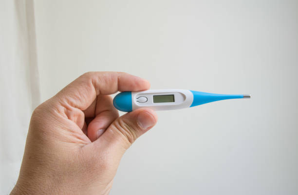 istock Women hands holding a digital thermometer 1257326694