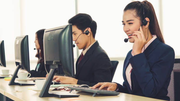 istock Business people wearing headset working in office 1257329686
