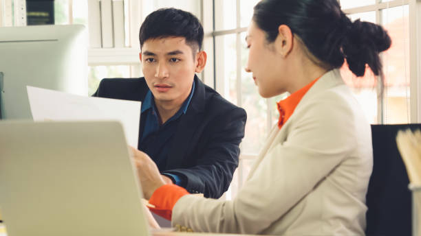 istock Two business people talk project strategy at office 1257330924