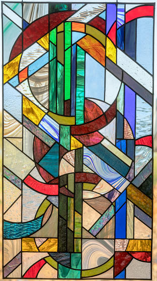 Very colorful stained glass. When you feel it, it's real glass and has sharp parts. It's not flush but jagged. Looks like bricks.