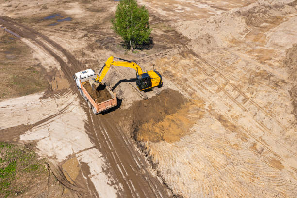 istock yellow excavator loading a dump truck on construction site. aerial photo 1257332708