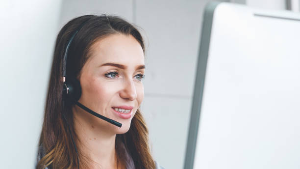 istock Business people wearing headset working in office 1257332825