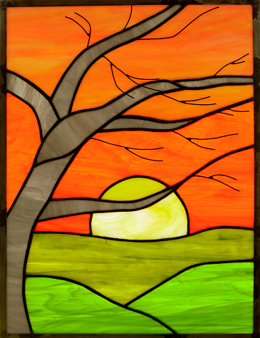 Leaded Stained Glass of Sun Rising or Setting over Green Meadow with Tree and Orange Sky.