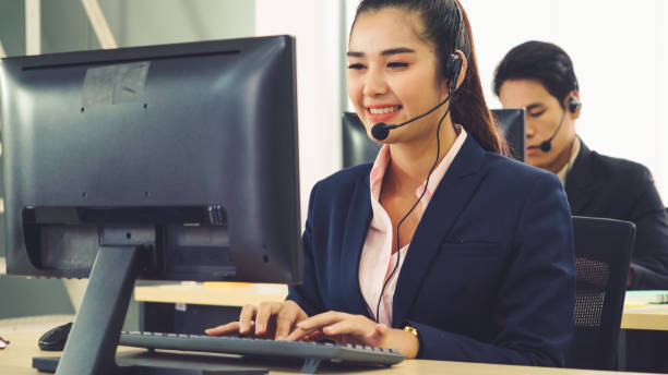 istock Business people wearing headset working in office 1257333641