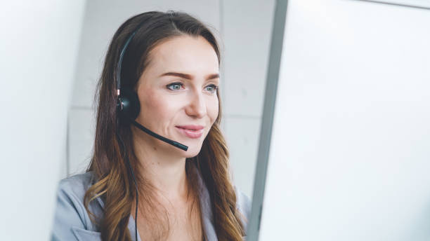 istock Business people wearing headset working in office 1257334317