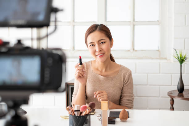istock Asian woman beauty blogger/vlogger teaching for make up cosmetic tutorial via internet online broadcasting live streaming 1257335183