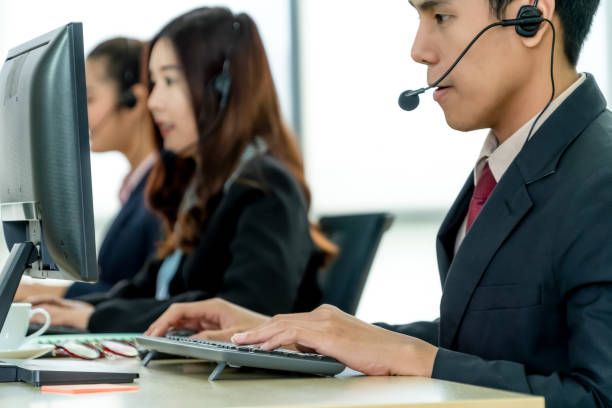 istock Business people wearing headset working in office 1257335204