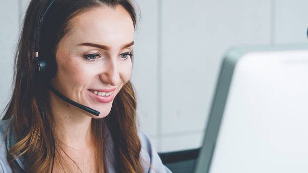 istock Business people wearing headset working in office 1257335232