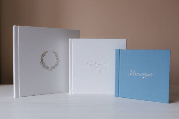 istock Three different photobooks on white wooden table. Comparison 1257335882