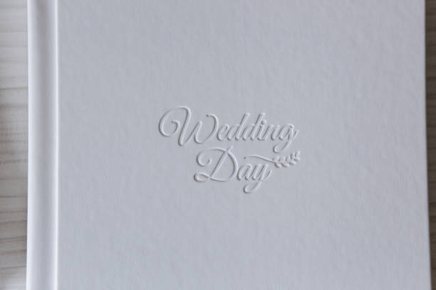 Photobook with different lettering on white wooden table.