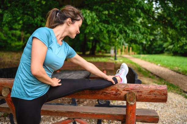 istock Woman stretching before running in park. 1257335905