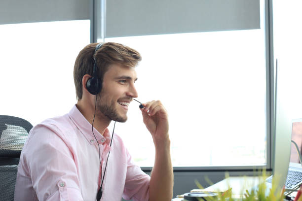 istock Happy young male customer support executive working in office. 1257335962