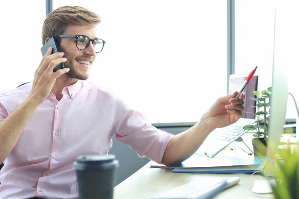 istock Businessman using his mobile phone in the office. 1257335975