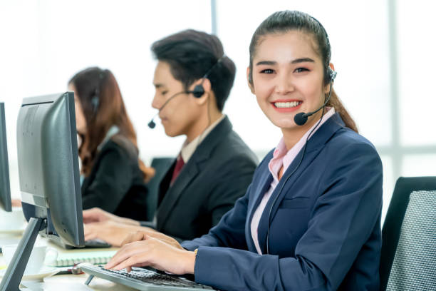 istock Business people wearing headset working in office 1257336049
