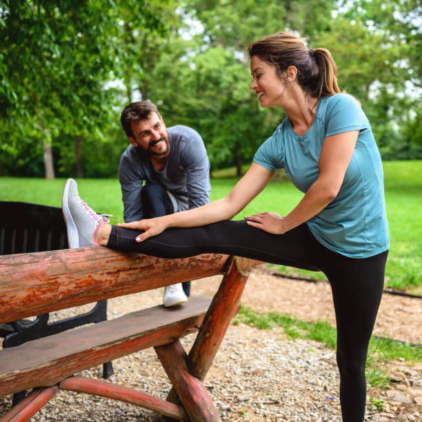 istock Warm up - couple exercising before jogging 1257336072