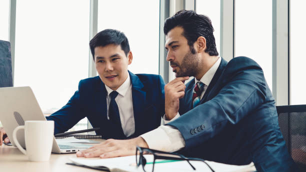 istock Two business people talk project strategy at office 1257336152