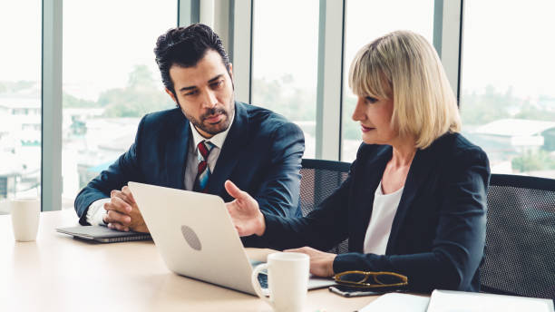 istock Two business people talk project strategy at office 1257336882