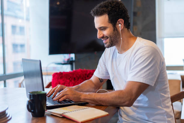 istock Man studying from home with his laptop passing the COVID-19 quarantine 1257336918