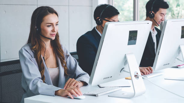 istock Business people wearing headset working in office 1257337032