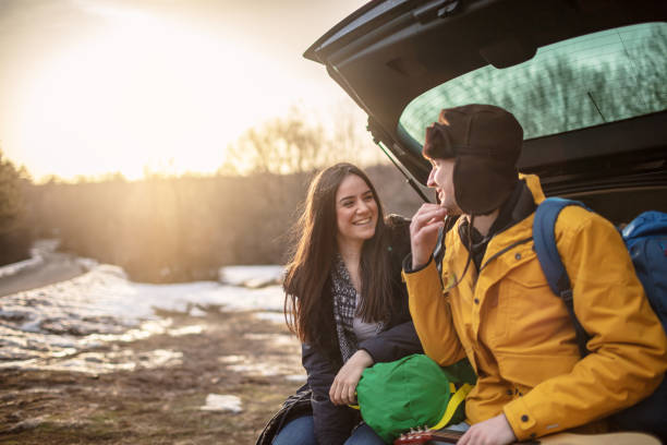 istock Yong couple resting on a car 1257337715
