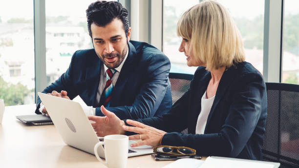 istock Two business people talk project strategy at office 1257337868