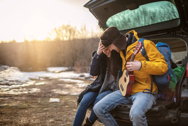 istock Yong couple with guitar in car trunk 1257337909