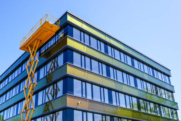 istock modern building facade repair using a high scissor lift with a platform 1257338882