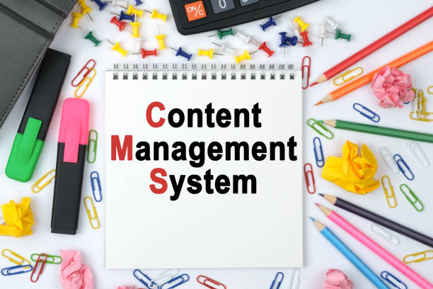 istock On the table is a calculator, diary, markers, pencils and a notebook with the inscription - Content Management System 1257339117