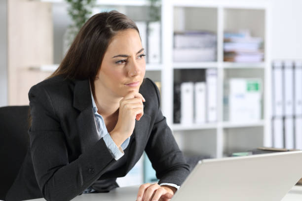 istock Pensive executive thinking looking away in the office 1257340765