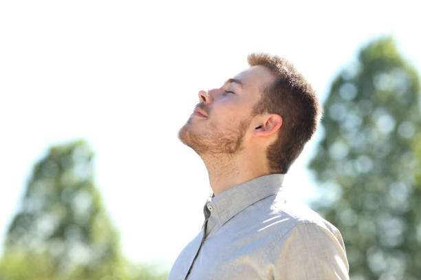 istock Man breathing fresh air standing outdoors 1257340789