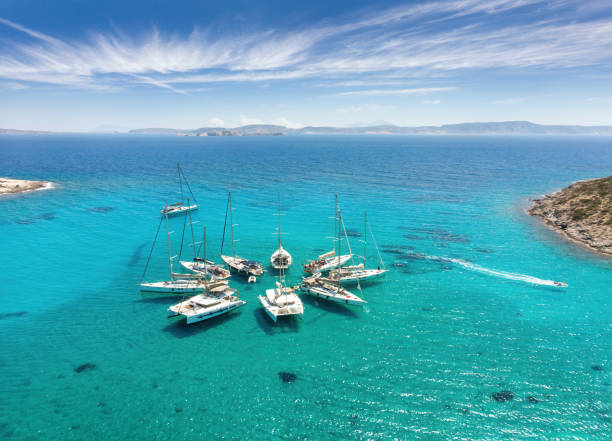 Sailing boats in star formation in Greece (Polyaigos, Cyclades) the largest uninhabited island of the Aegean Sea and one of the best and most beautiful sailing destinations stock photo
