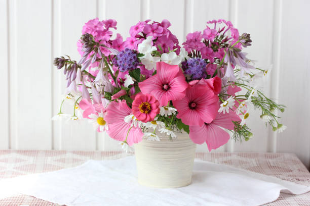 istock pink garden flowers on the table on a light background. 1257344287