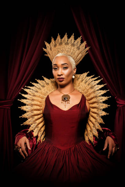 Historical mixed race Queen character on the throne Beautiful mixed race historical african Queen character wearing a period dress in a studio shot queen royal person stock pictures, royalty-free photos & images