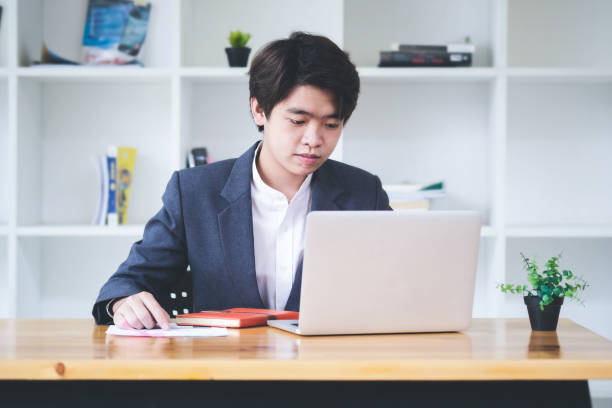 istock Financial analyst with business research data  information on laptop computer screen in work office. 1257345349