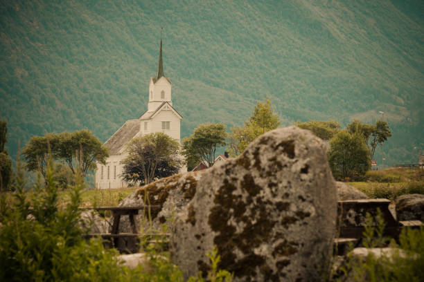 Mountain landscape and the white wooden Oppstryn Church in Stryn Municipality in Sogn og Fjordane county, Norway.