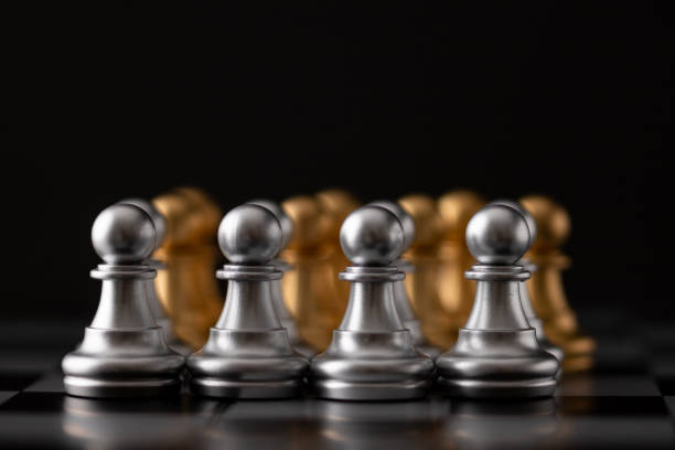 istock gold and silver chessman in the game 1257345965