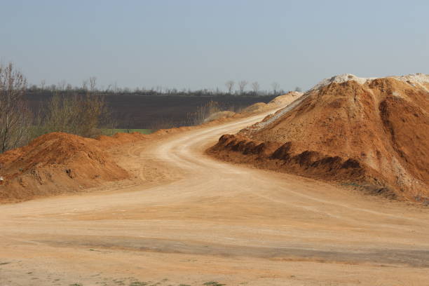 istock Clay mining. Waste soil hill and quarry road. 1257346040
