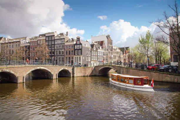 Amsterdam, Netherlands - 04 17 2016: Keizersgracht canal bridges in Amsterdam, Netherlands. Amsterdam is home to more than one hundred kilometers of canals, most of which are navigable by boat.