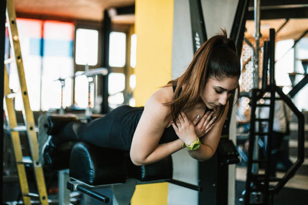 istock Young woman exercising in the gym 1257349320