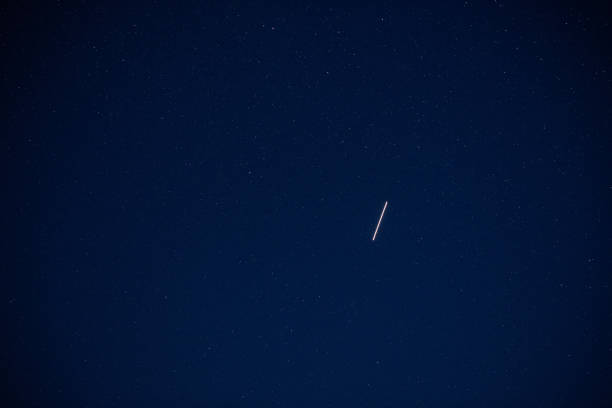 istock a satellite flies high up  in the sky in the dark night 1257349751