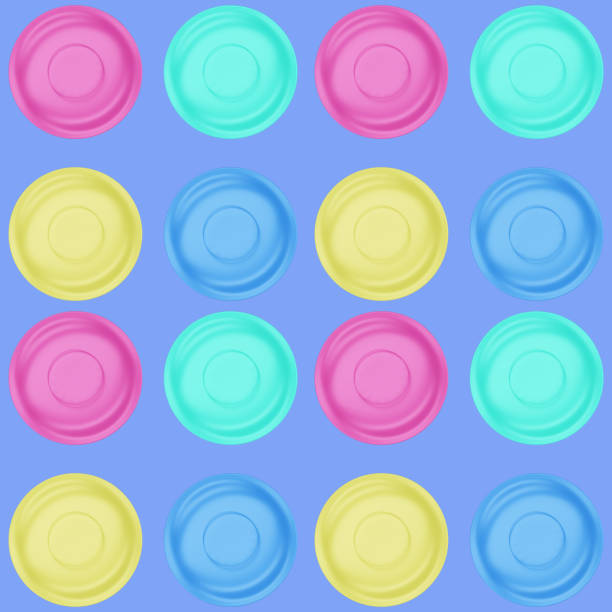istock colored dinner plates isolated on blue, seamless pattern, set the table for the holiday, view from above. 3d render 1257351102