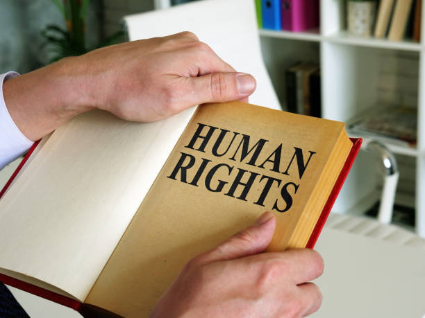 istock Lawyer opened a book with human rights law. 1257353423