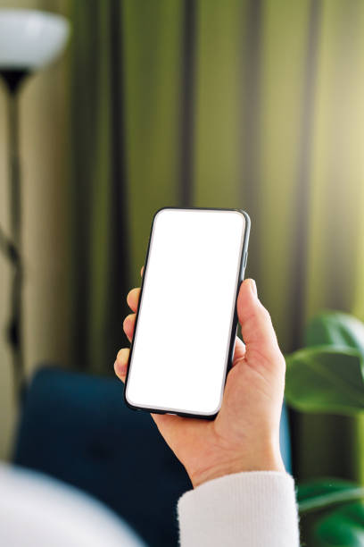 istock Woman holding and touching blank screen template smart phone. Smart phone screen is empty. 1257354356