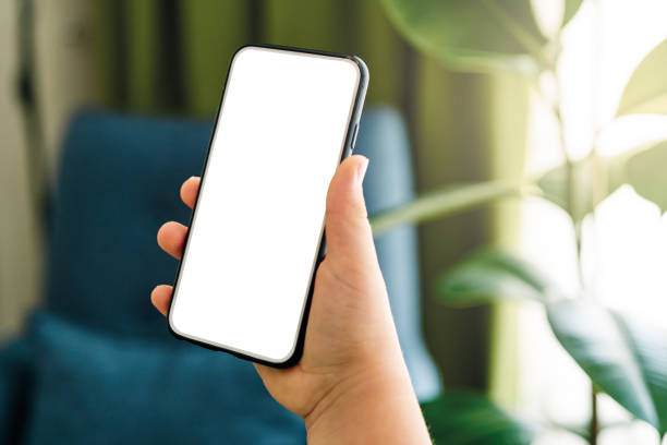 istock 6-7 years child holding and touching smart phone. Smart phone screen empty. 1257354481