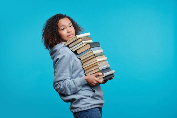 istock Carrying big stack of books 1257354684