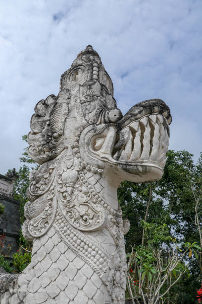 traditional indonesian art and symbol of balinese hindu religion - faces of mythological dragons in front of lempuyang temple entrance. bali people culture and asian travel backgrounds - bali sculpture balinese culture human face imagens e fotografias de stock