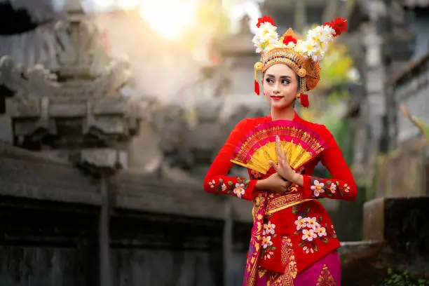 Photo of Indonesian girl with traditional costumn dance in bali temple